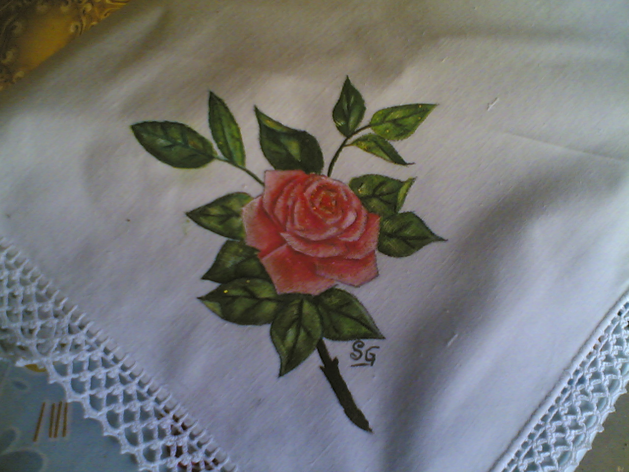 um paninho de tabuleiro com uma rosa 
